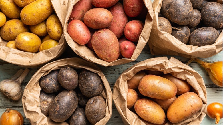 various potatoes in paper bags