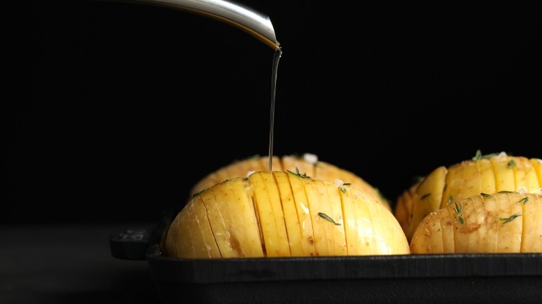 Pouring oil on uncooked potatoes