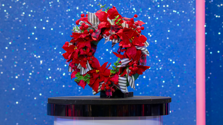 Holiday wreath cake against a sparkly blue background