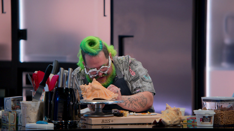 Andrew Fuller painting his conch shell cake