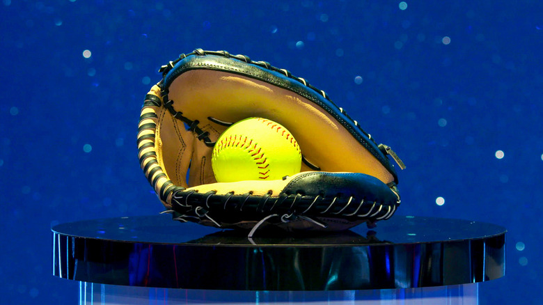 Baseball glove cake with a neon yellow softball