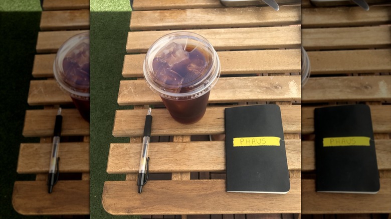 Coffee and notebook on bench