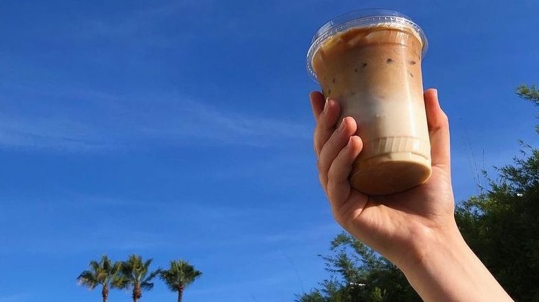 Person holding iced latte