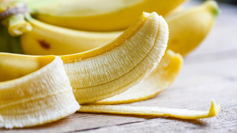 Peeled banana on table