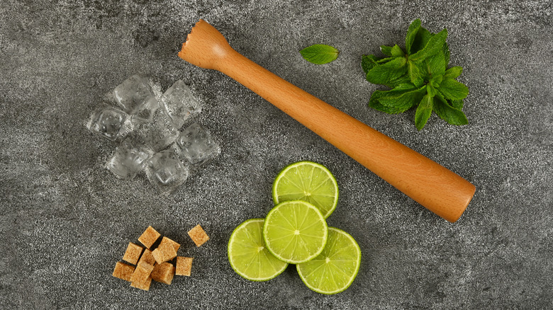 Muddler with cocktail ingredients