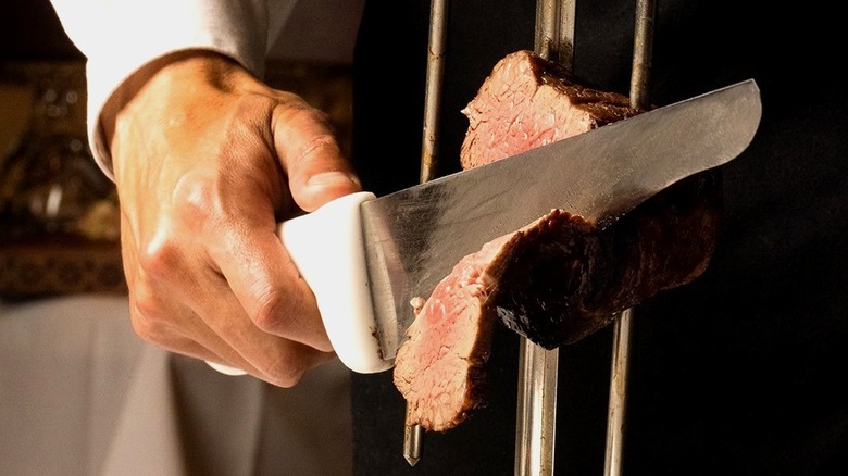 hand slicing meat