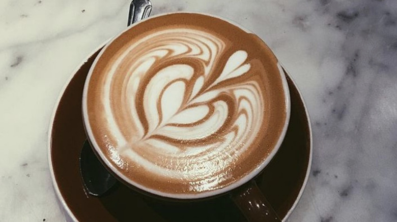 Latte in cup with saucer