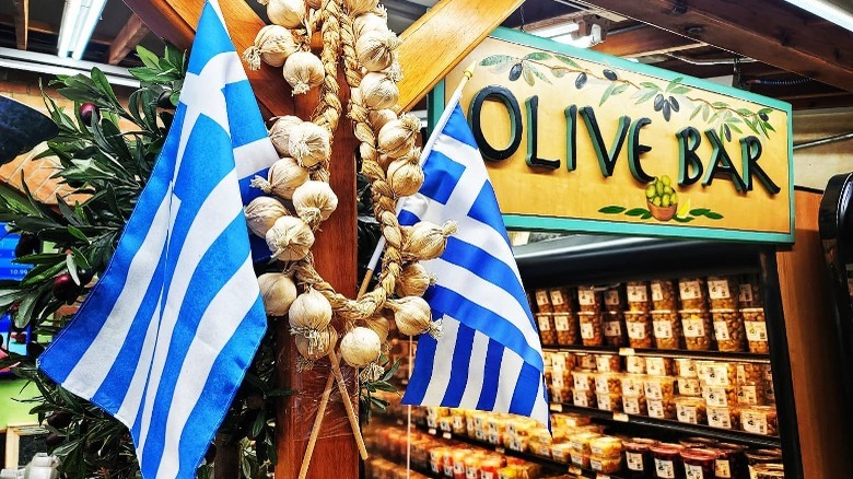 Greek flags and olive bar sign