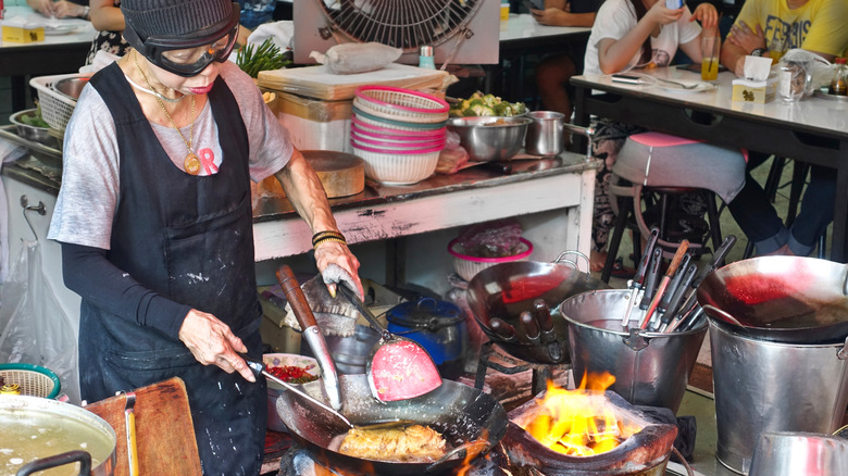 Jay Fai cooking an omelet