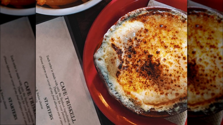 Red bowl of French onion soup 