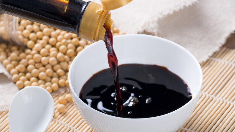 Pouring soy sauce in dish