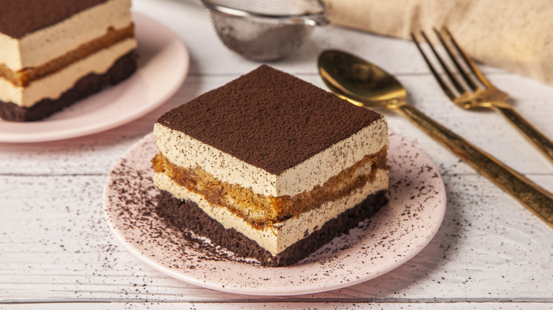 slice of tiramisu on a plate with cutlery