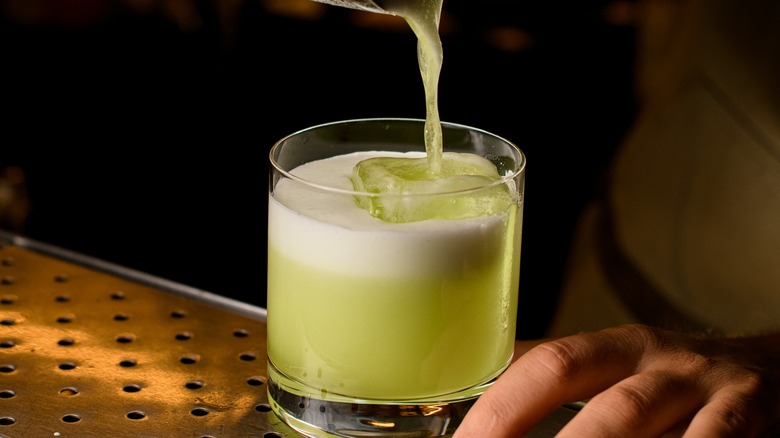 green cocktail with froth