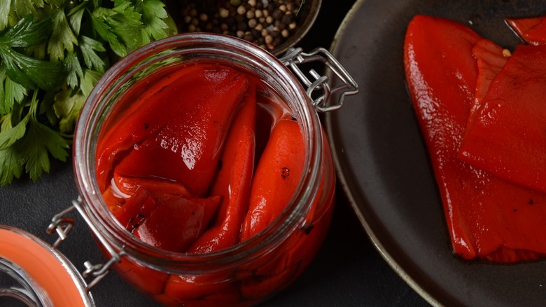 Open jar of red peppers