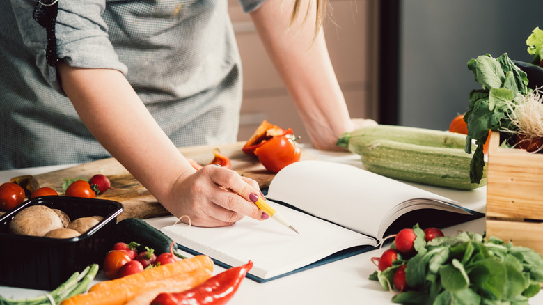 taking notes with vegetables around