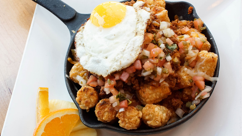 Totchos in skillet with egg