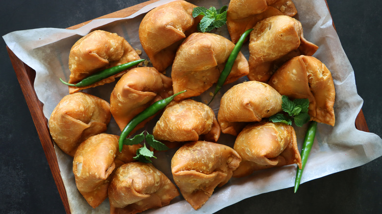 Samosas on wooden tray