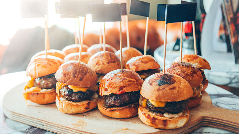 Hamburger sliders on wooden peel