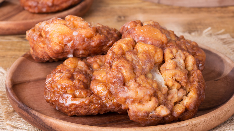 Apple fritters on wooden plate