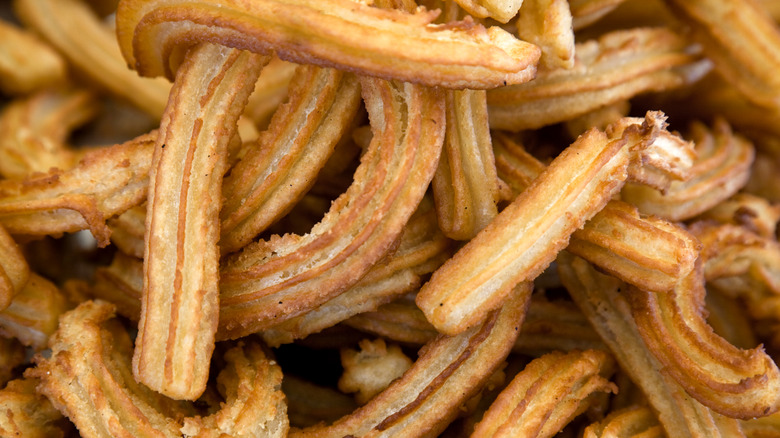 Fried piped churros as background