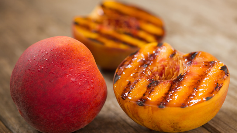 Grilled peaches on surface