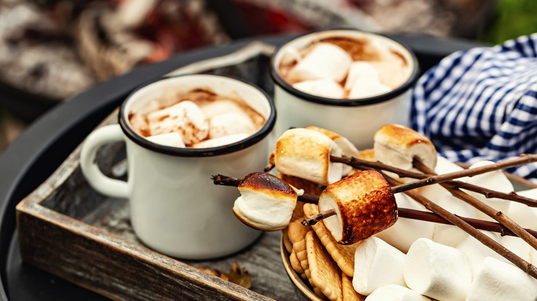 Hot cocoa with campfire in background