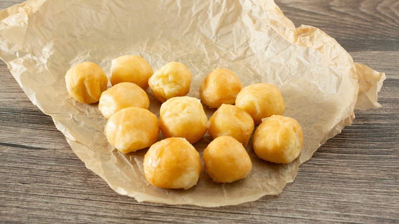 Glazed donut holes on paper