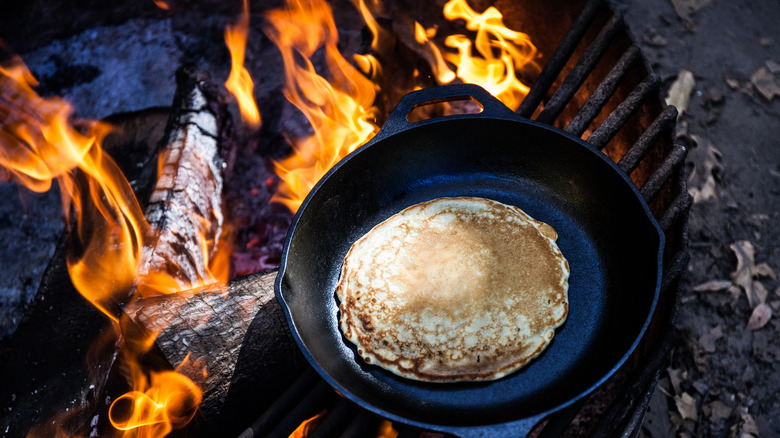 Cooking pancakes over a fire