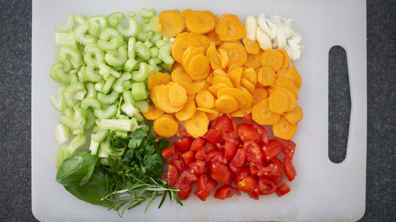 Colorful diced vegetables on cutting board