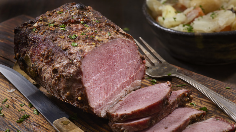 Slow cooked corned beef on cutting board