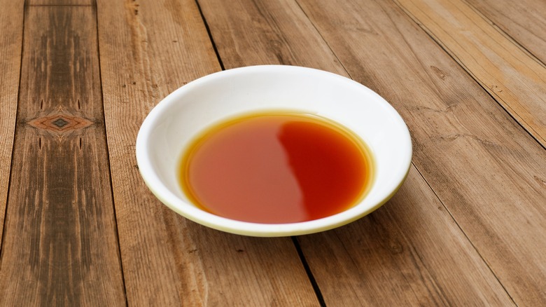 Bowl of fish sauce on table