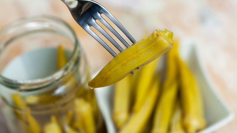 pickled okra pierced on fork