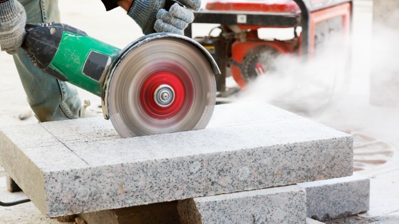 man cutting marble slab