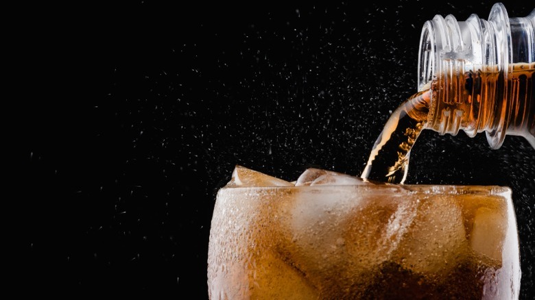 pouring soda into glass