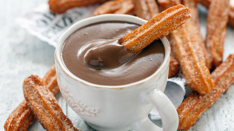 Churro dunked into chocolate