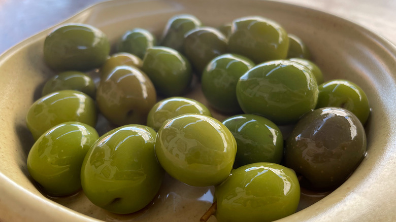 Shiny spanish olives in dish