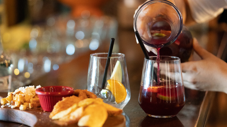 pouring cold red sangria fruit