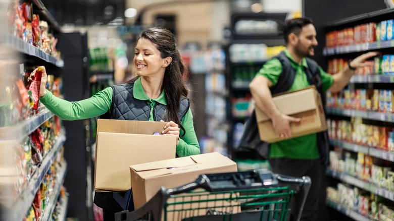 employees stocking grocery store shelves