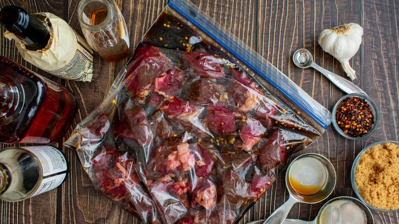 Steak tips marinating in Worcestershire sauce