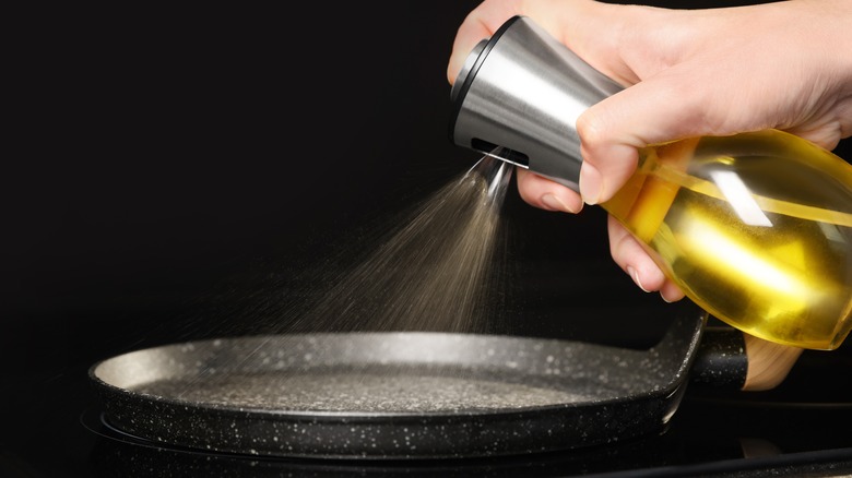 Person using cooking spray