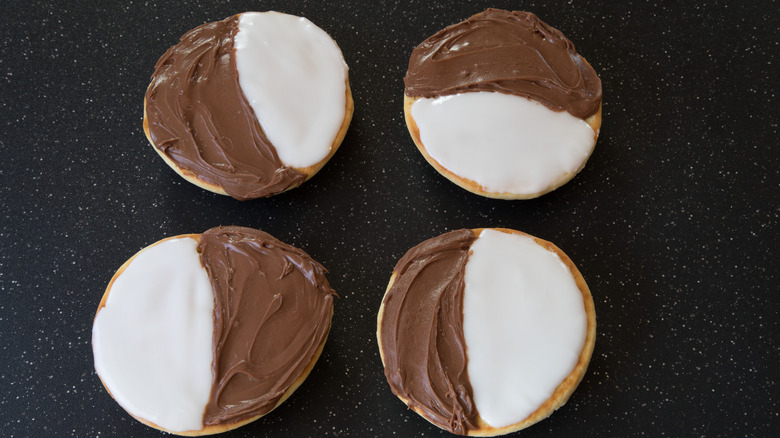 four iced black and white cookies