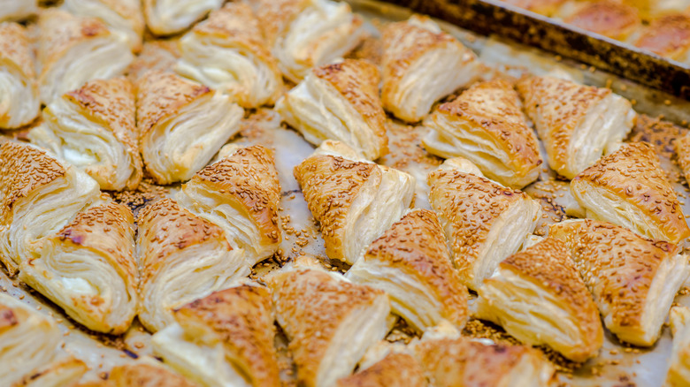 tray filled with sesame seeded bourekas