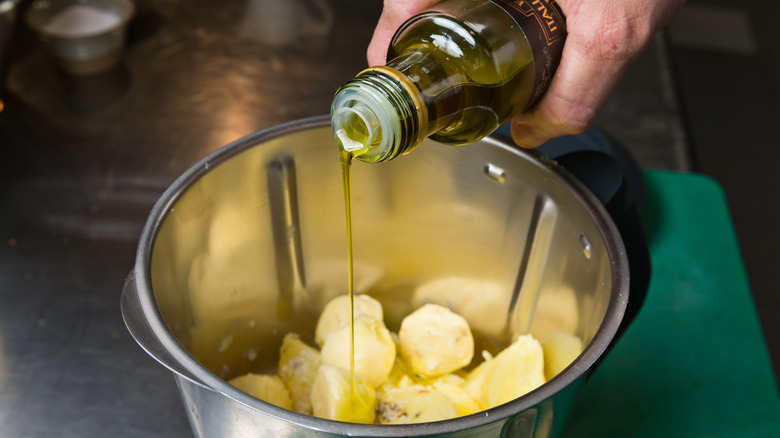 Drizzling olive oil on potatoes