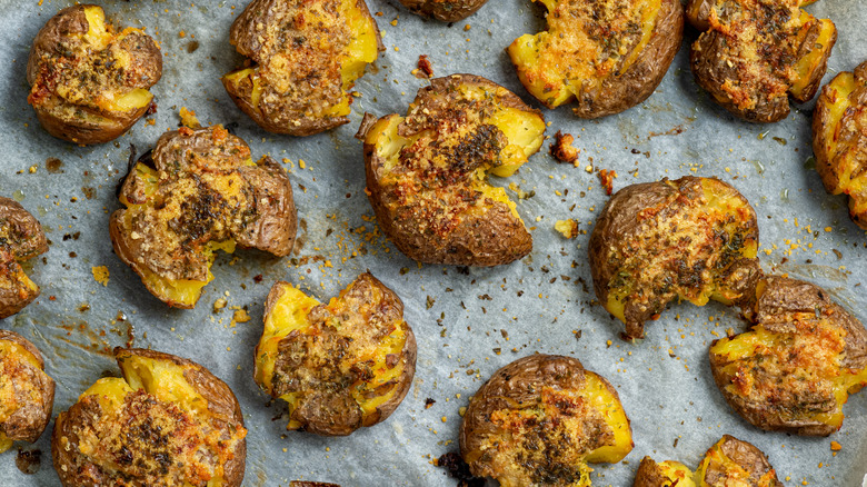 Smashed potatoes on a parchment sheet