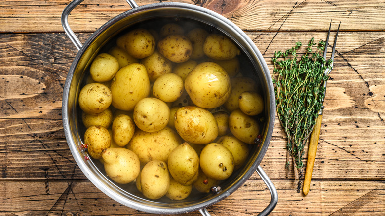 pot of water submerged potatoes