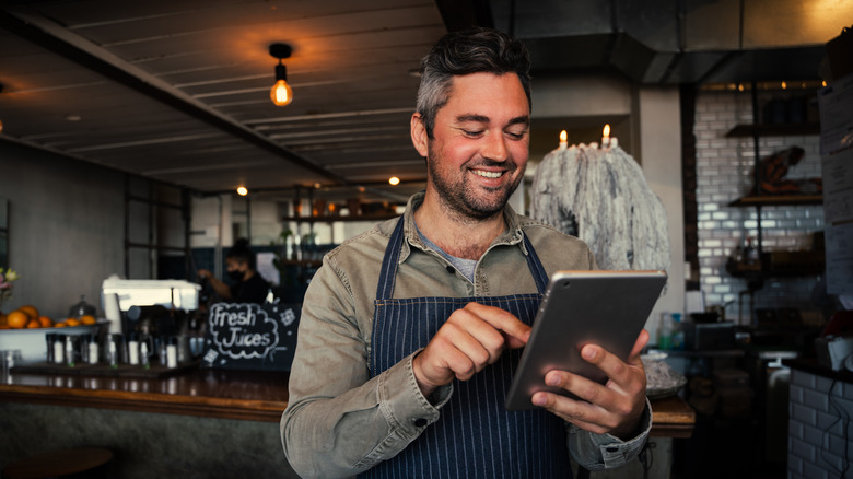 waiter typing order on tablet 