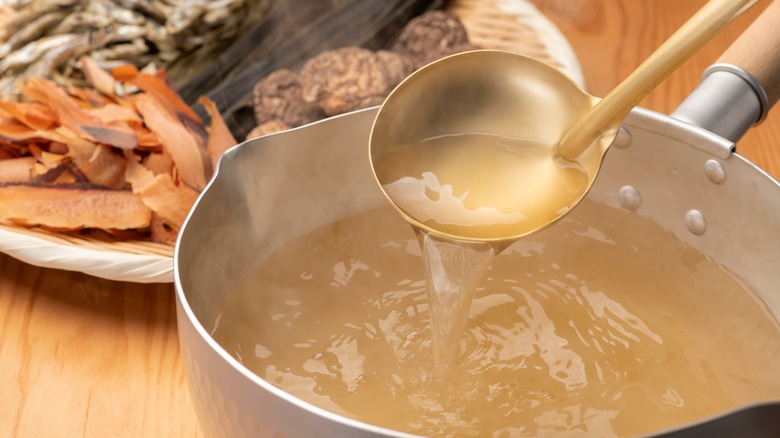 Dashi broth in pot with ladle