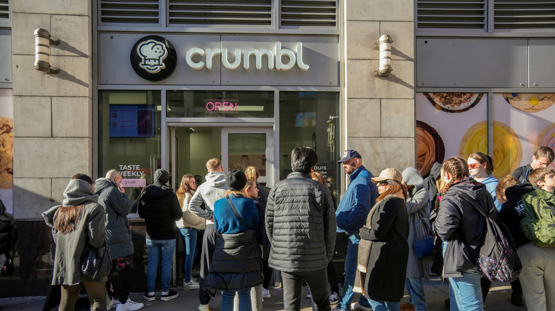 Cookie lovers line up outside the popular Crumbl store