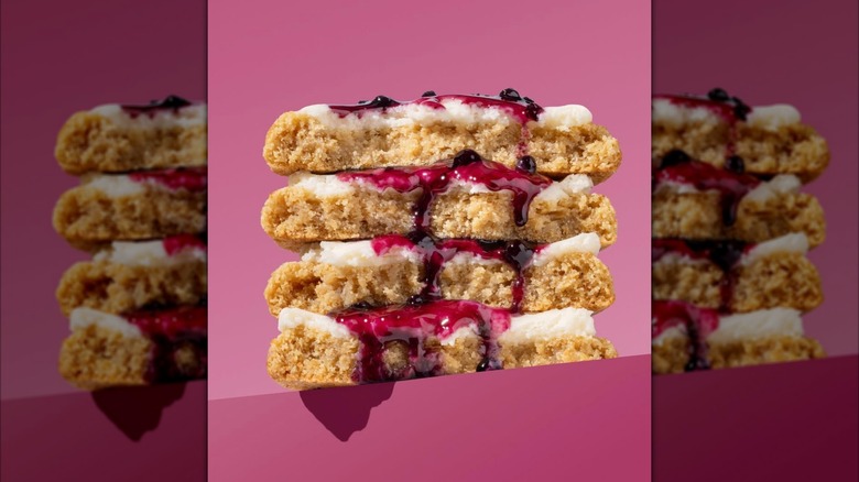 Pile of berry cookies with frosting and jam