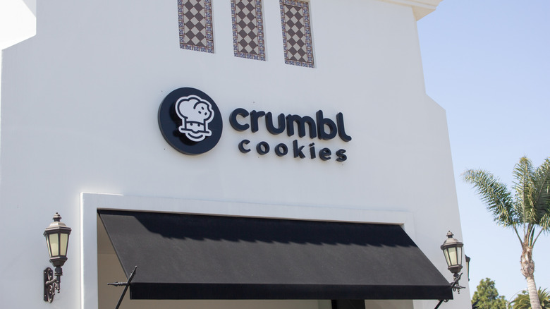 A store front sign for Crumbl Cookies
